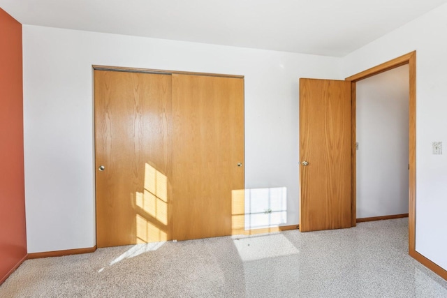 unfurnished bedroom with light colored carpet and a closet