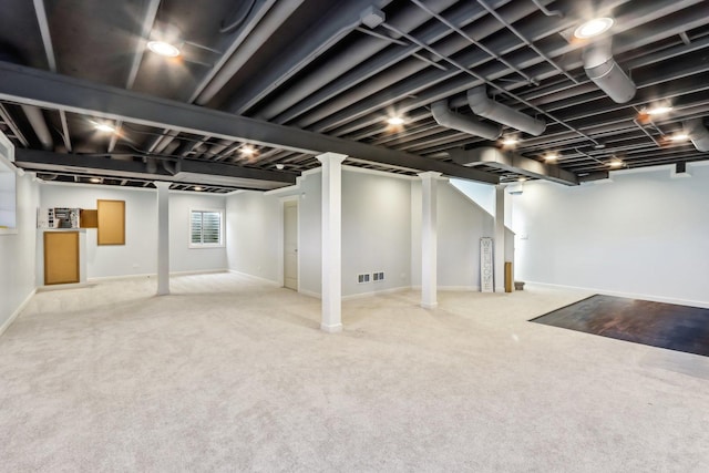 basement featuring light carpet