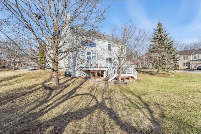 back of house featuring a yard and a deck