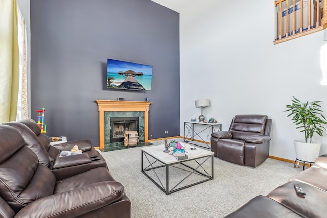 living room with carpet and a fireplace