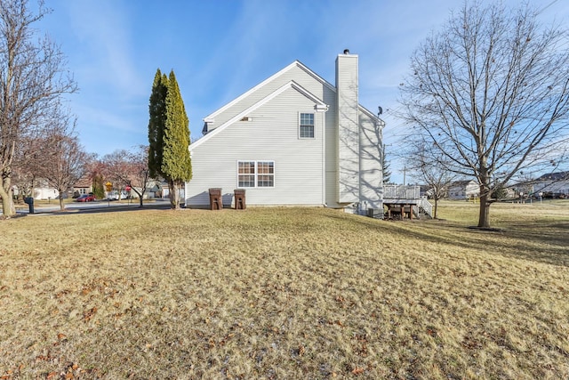 back of property featuring a yard