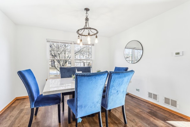 dining area featuring a chandelier and dark hardwood / wood-style floors