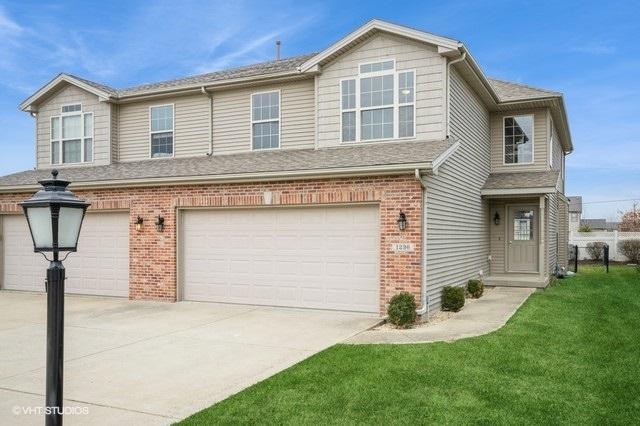 view of front of property with a garage and a front lawn