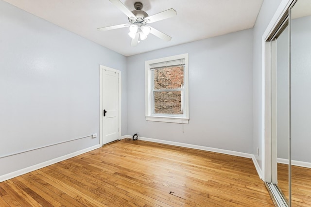 unfurnished bedroom with ceiling fan, a closet, and light hardwood / wood-style floors