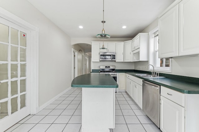 kitchen featuring white cabinets, a kitchen island, sink, and stainless steel appliances