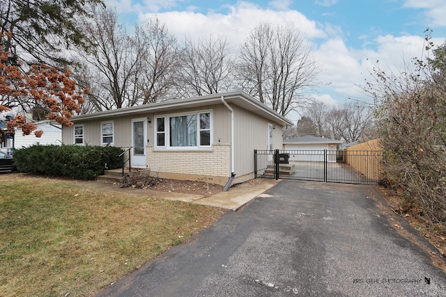 view of front of property with a garage, an outdoor structure, and a front yard