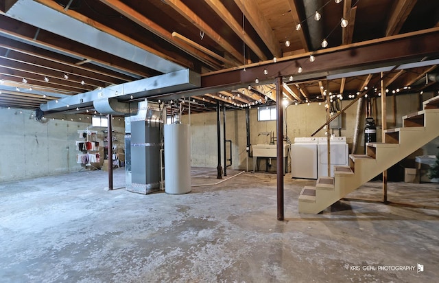 basement featuring washer and dryer, gas water heater, and heating unit