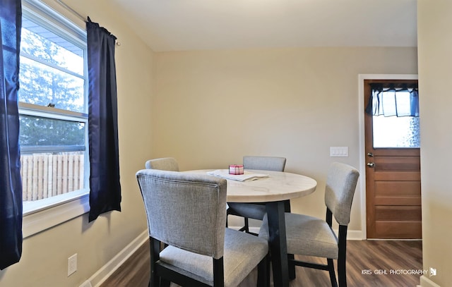 dining space featuring dark wood-type flooring and a healthy amount of sunlight