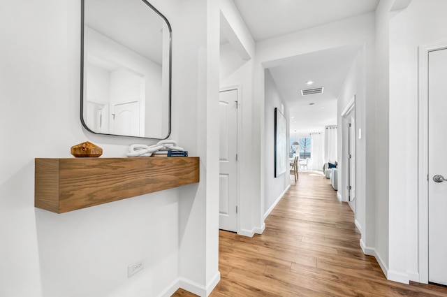 corridor with light hardwood / wood-style flooring