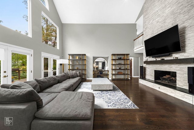 living room with a wealth of natural light, french doors, and hardwood / wood-style flooring