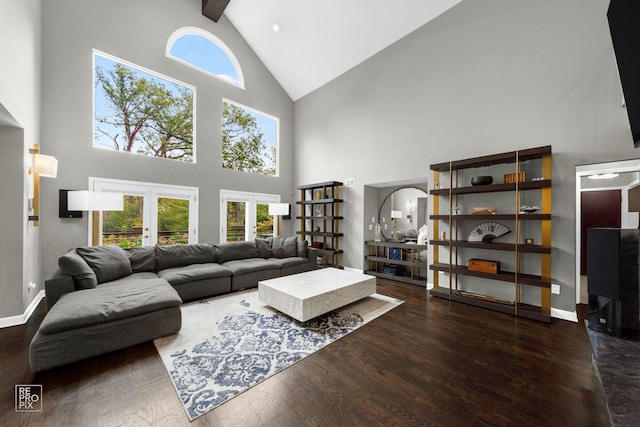 living room with beam ceiling, dark wood-type flooring, high vaulted ceiling, and french doors