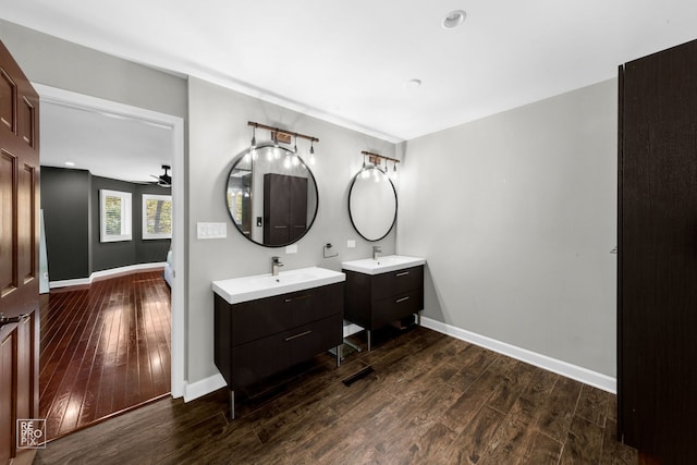 bathroom featuring ceiling fan, wood-type flooring, and vanity