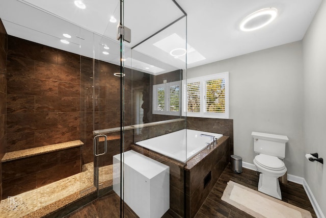 bathroom featuring toilet, wood-type flooring, and shower with separate bathtub