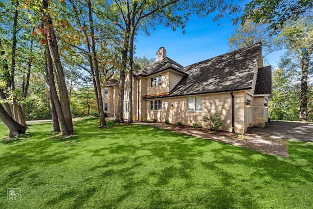 view of front of property featuring a garage and a front lawn