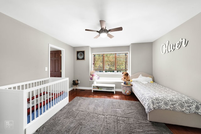 bedroom with ceiling fan and dark hardwood / wood-style floors