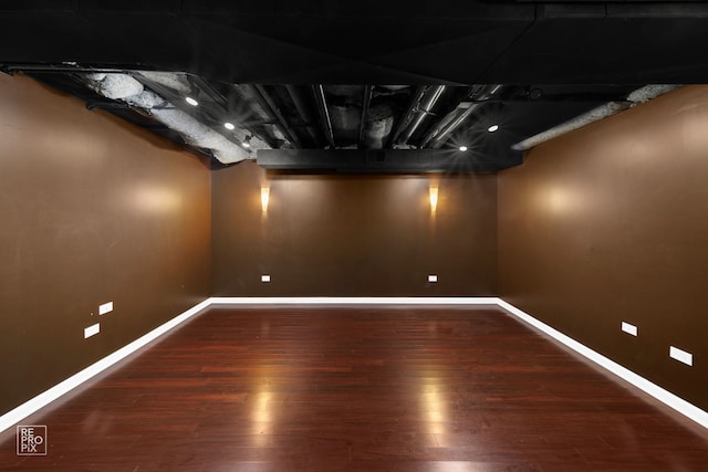 basement with dark hardwood / wood-style floors