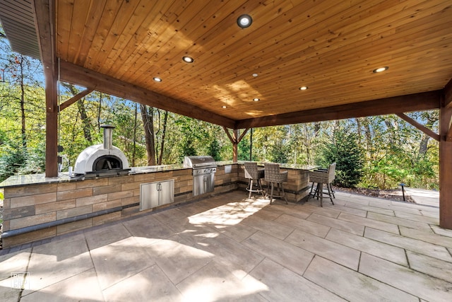 view of patio with a grill, exterior kitchen, and an outdoor bar