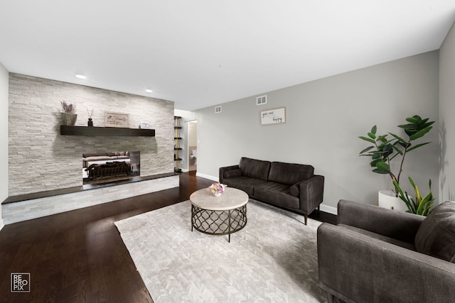 living room with hardwood / wood-style floors and a fireplace