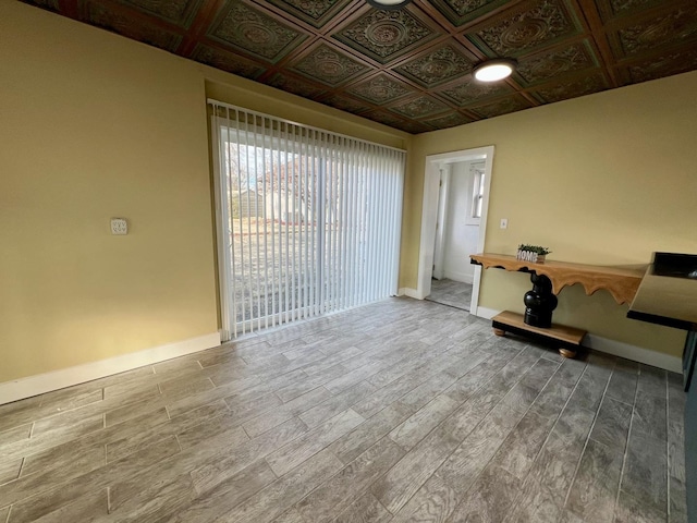 unfurnished room with hardwood / wood-style floors and coffered ceiling