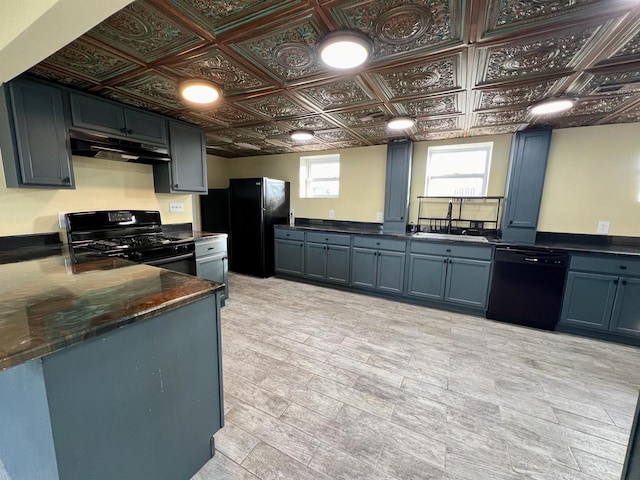 kitchen with kitchen peninsula, light wood-type flooring, sink, and black appliances