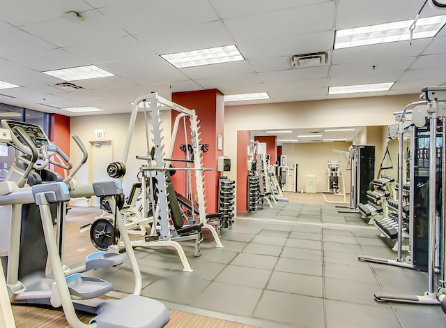 exercise room featuring a drop ceiling