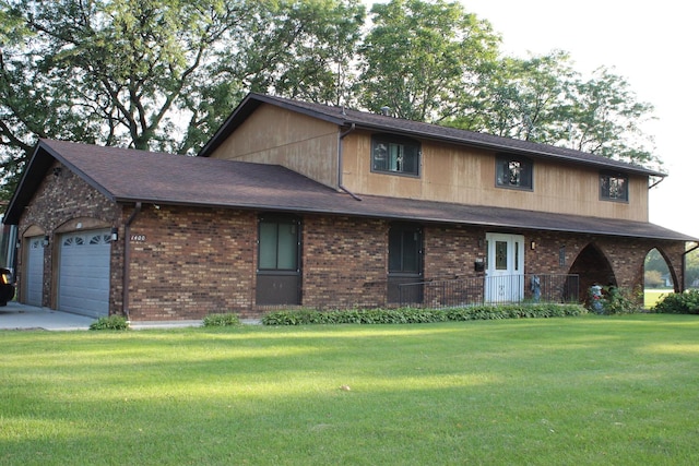 view of front of house with a front yard and a garage