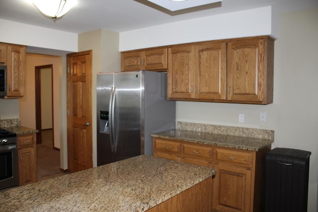 kitchen featuring light stone counters and appliances with stainless steel finishes