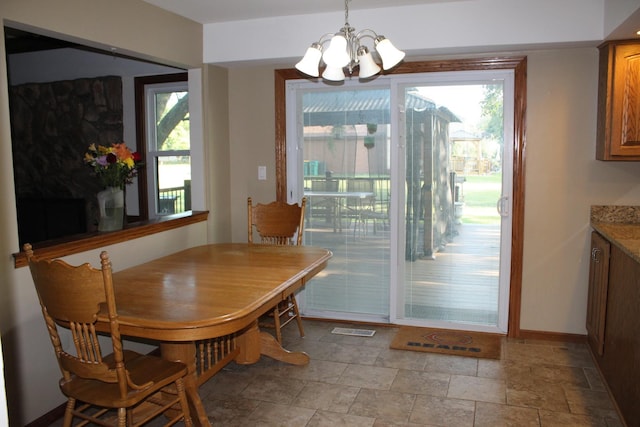 dining area with an inviting chandelier