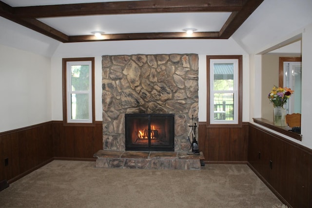 unfurnished living room with carpet, plenty of natural light, and wooden walls