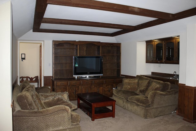 living room with lofted ceiling with beams, wooden walls, and light colored carpet