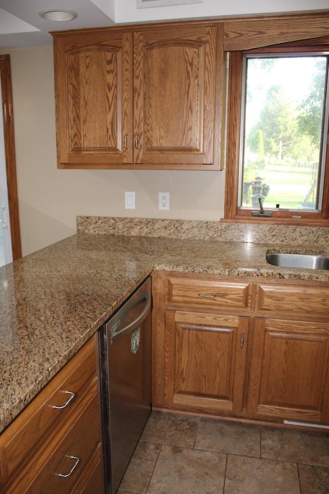 kitchen with light stone counters and dishwasher