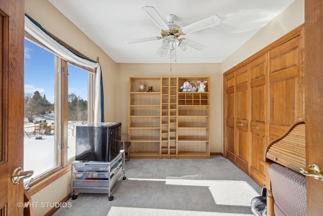 sitting room featuring plenty of natural light, light carpet, and ceiling fan