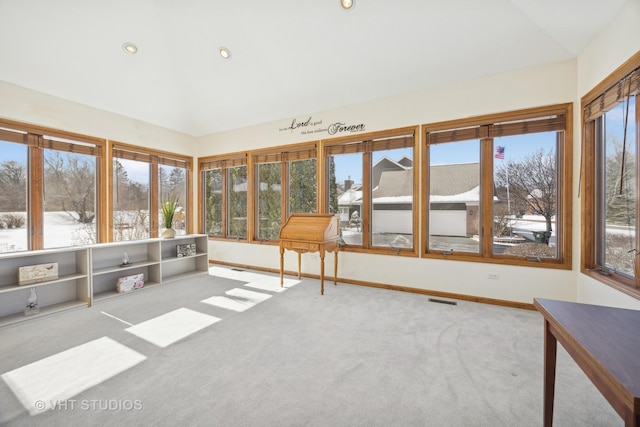 unfurnished sunroom featuring lofted ceiling and a wealth of natural light