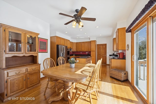 dining area featuring ceiling fan and light wood-type flooring