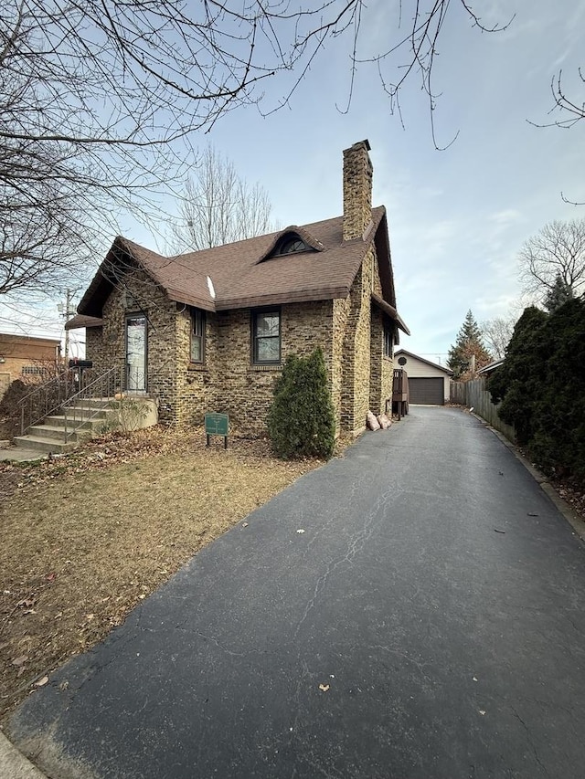 view of home's exterior with an outdoor structure and a garage