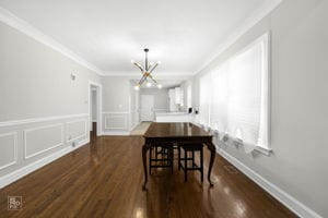 dining area with a notable chandelier, dark hardwood / wood-style floors, and crown molding