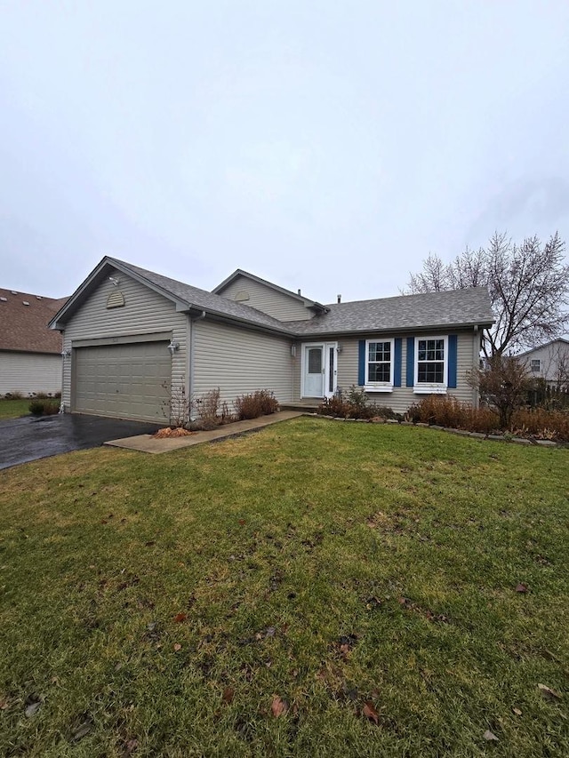 single story home featuring a yard and a garage