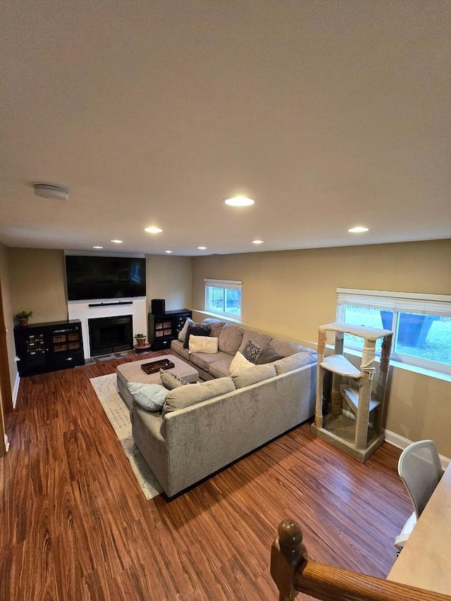 living room featuring dark hardwood / wood-style flooring, lofted ceiling, and a textured ceiling