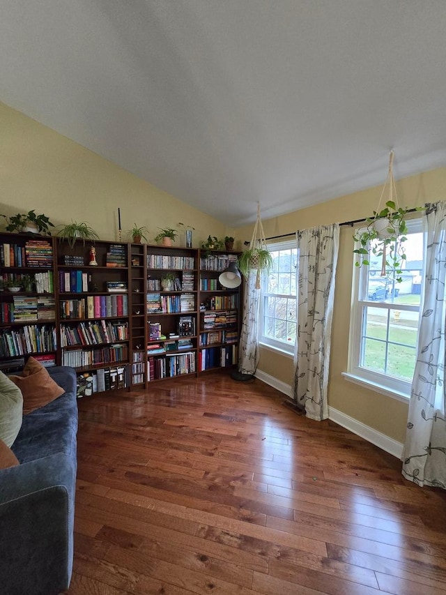 sitting room featuring dark hardwood / wood-style floors and lofted ceiling