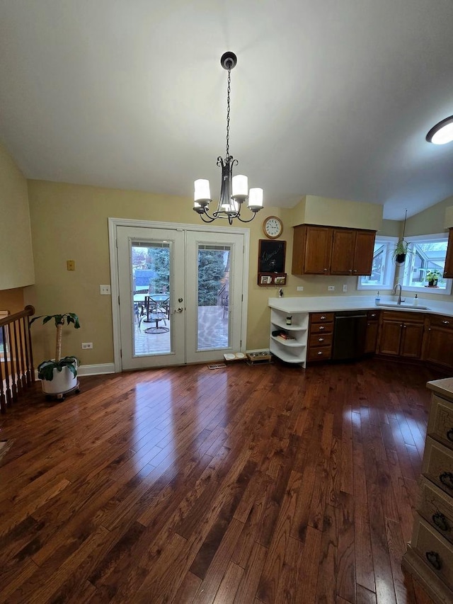 kitchen featuring sink, pendant lighting, a notable chandelier, dishwasher, and dark hardwood / wood-style floors