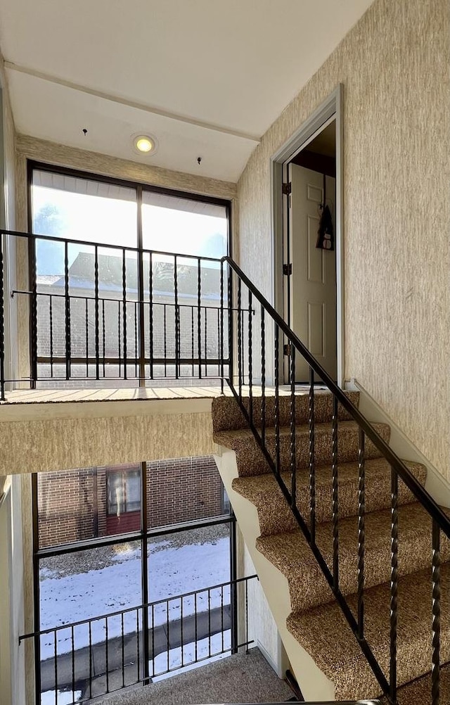 stairs with a healthy amount of sunlight and a water view