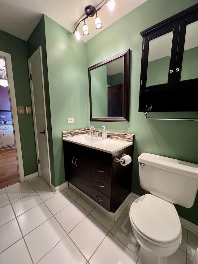 bathroom with tile patterned floors, vanity, and toilet