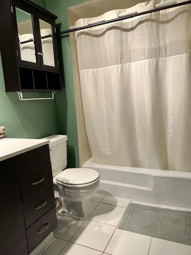 full bathroom featuring toilet, shower / bath combination with curtain, vanity, and tile patterned floors