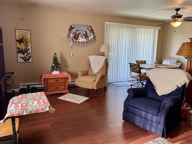 bedroom with baseboard heating, ceiling fan, and dark hardwood / wood-style flooring