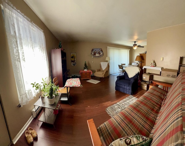 living room with ceiling fan and dark wood-type flooring