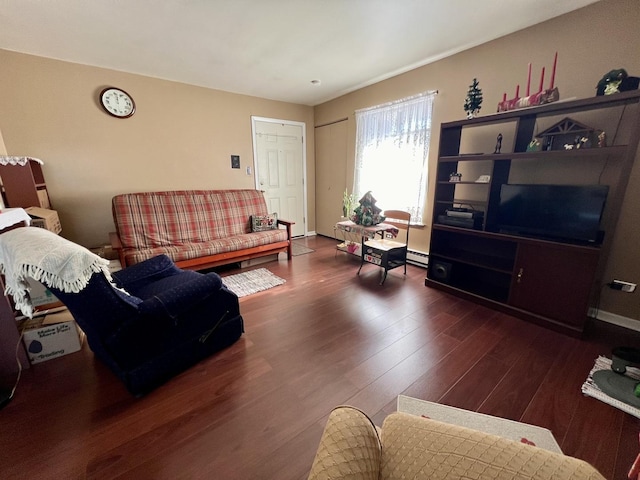 living room featuring dark hardwood / wood-style floors and a baseboard heating unit