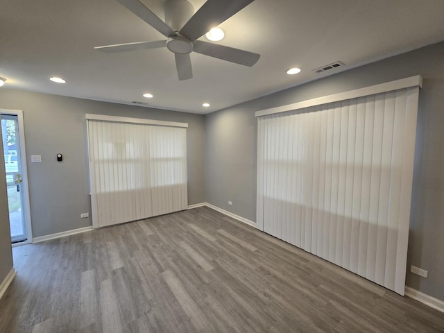 spare room featuring hardwood / wood-style flooring and ceiling fan