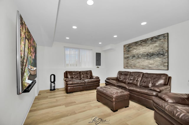 living room featuring light wood-type flooring and electric panel