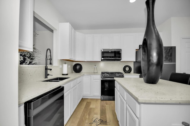 kitchen featuring tasteful backsplash, stainless steel appliances, sink, light hardwood / wood-style flooring, and white cabinetry