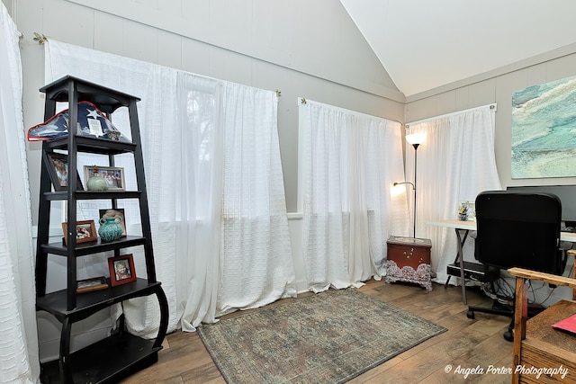 home office featuring dark hardwood / wood-style flooring and vaulted ceiling